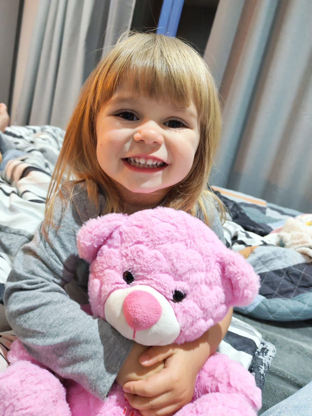 Haisley hugging her teddy bear